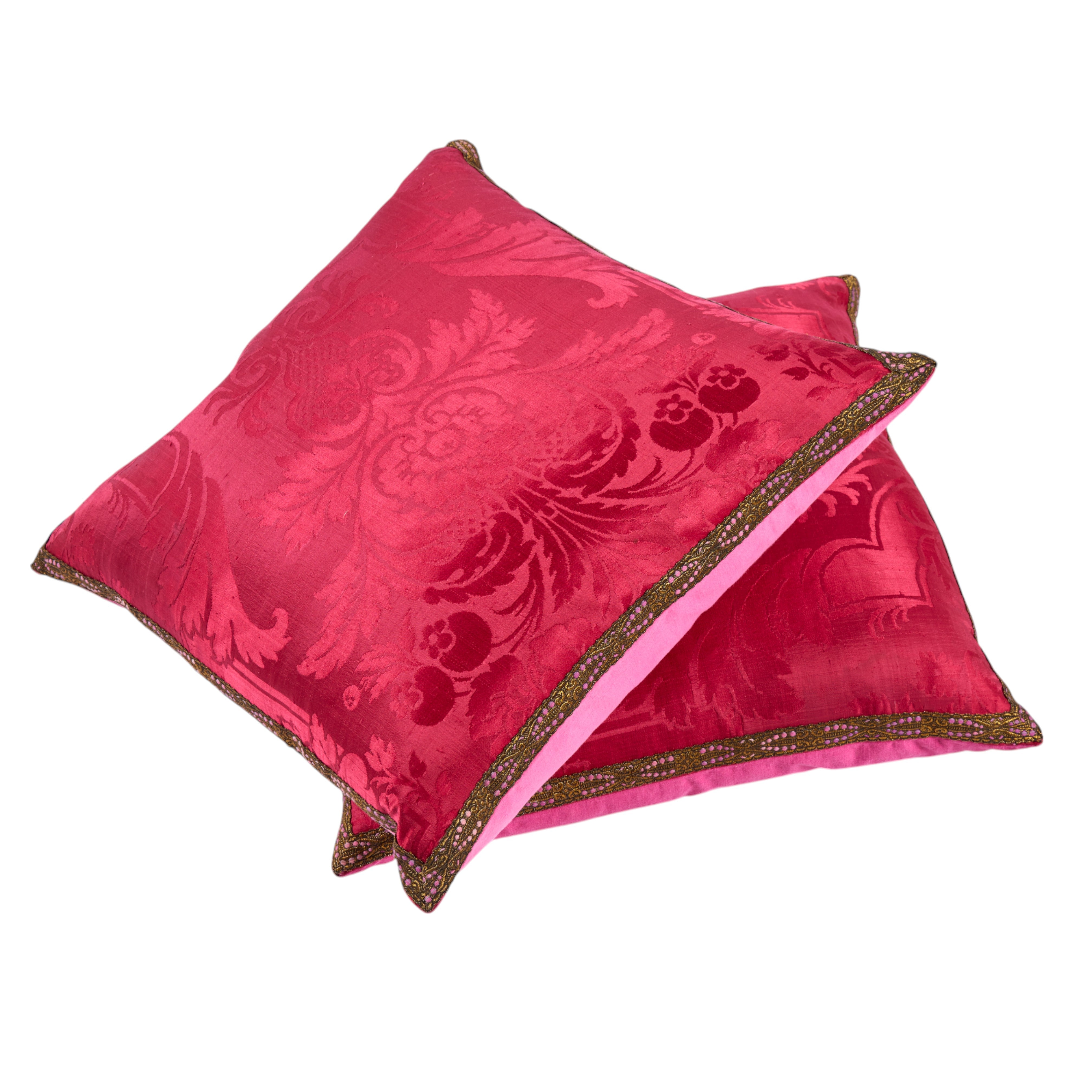 A large Pair of opulent Cranberry Silk 19th Century Damask Cushions with old gold flat braid decoration