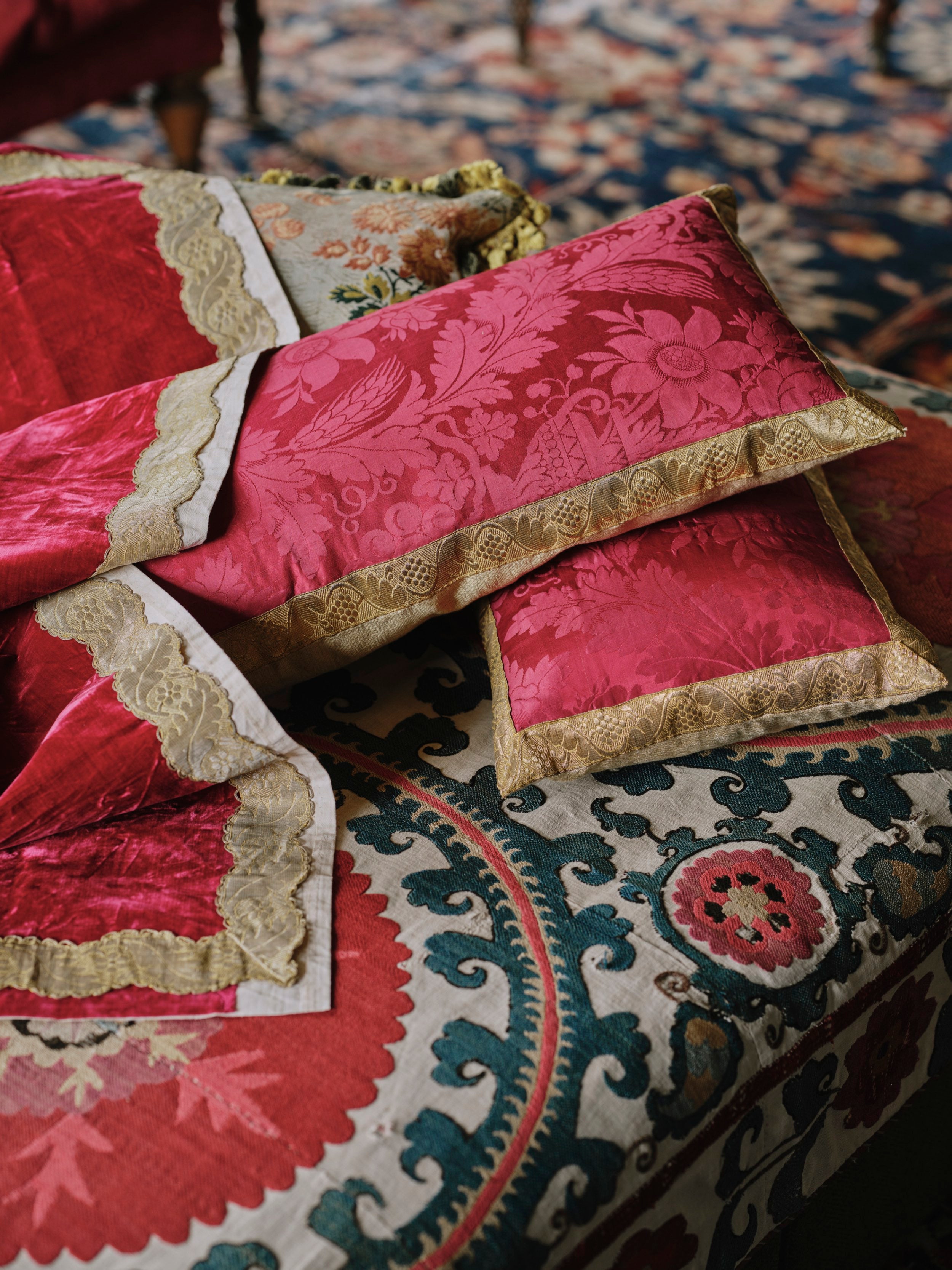 A Pair of Cushions made from an Early 19th Century Magenta Silk Damask with Antique Gold Braid