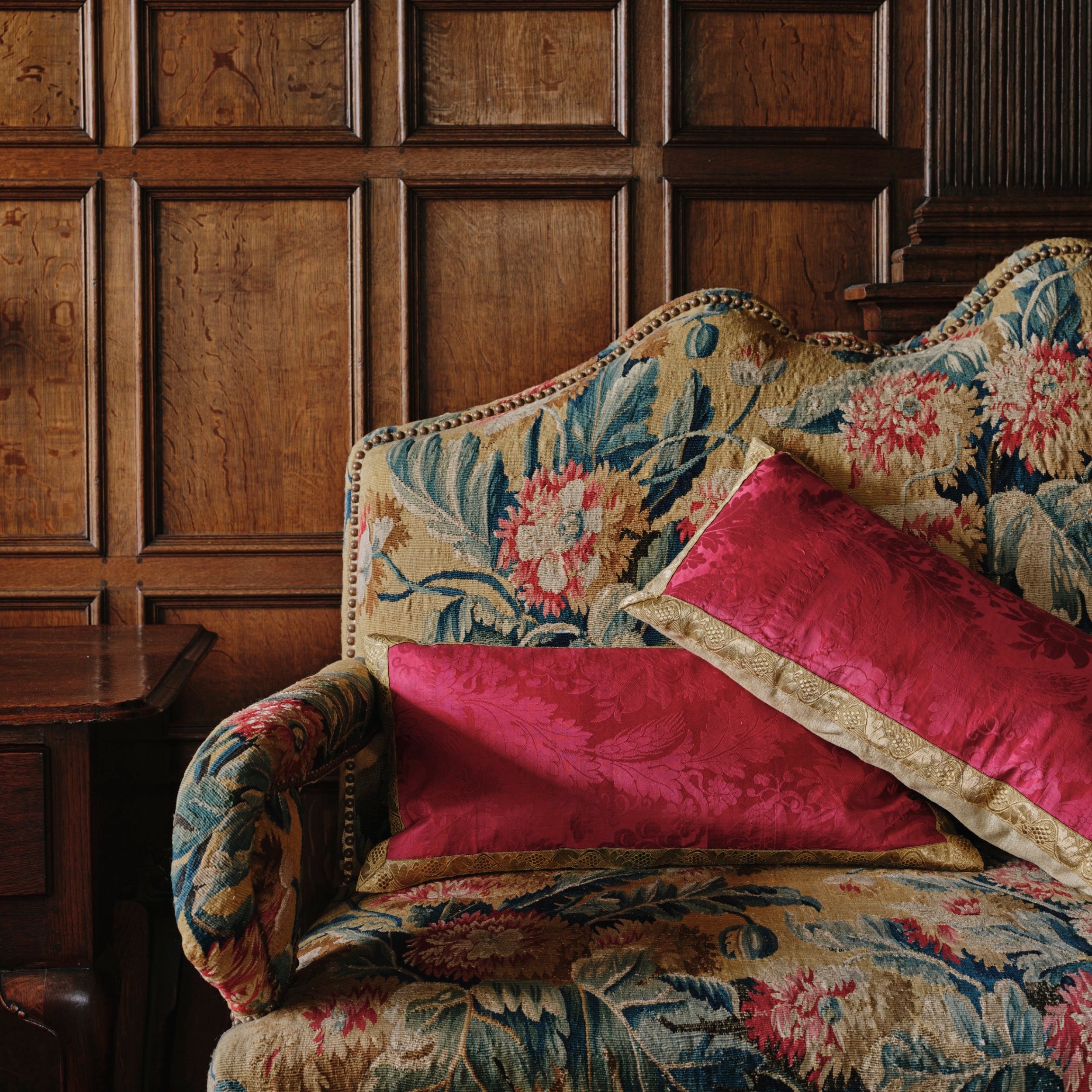 A Pair of Cushions made from an Early 19th Century Magenta Silk Damask with Antique Gold Braid