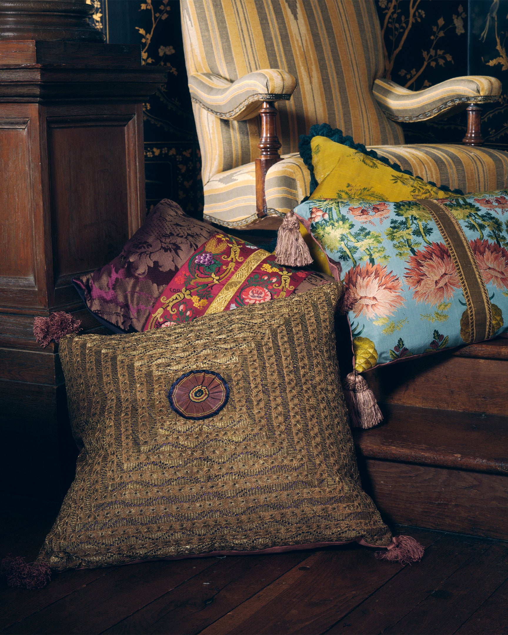 A large Old Gold cushion made with a rare 19th Century Ottoman panel with a handmade silk antique ribboned rosette and Italian silk tassels