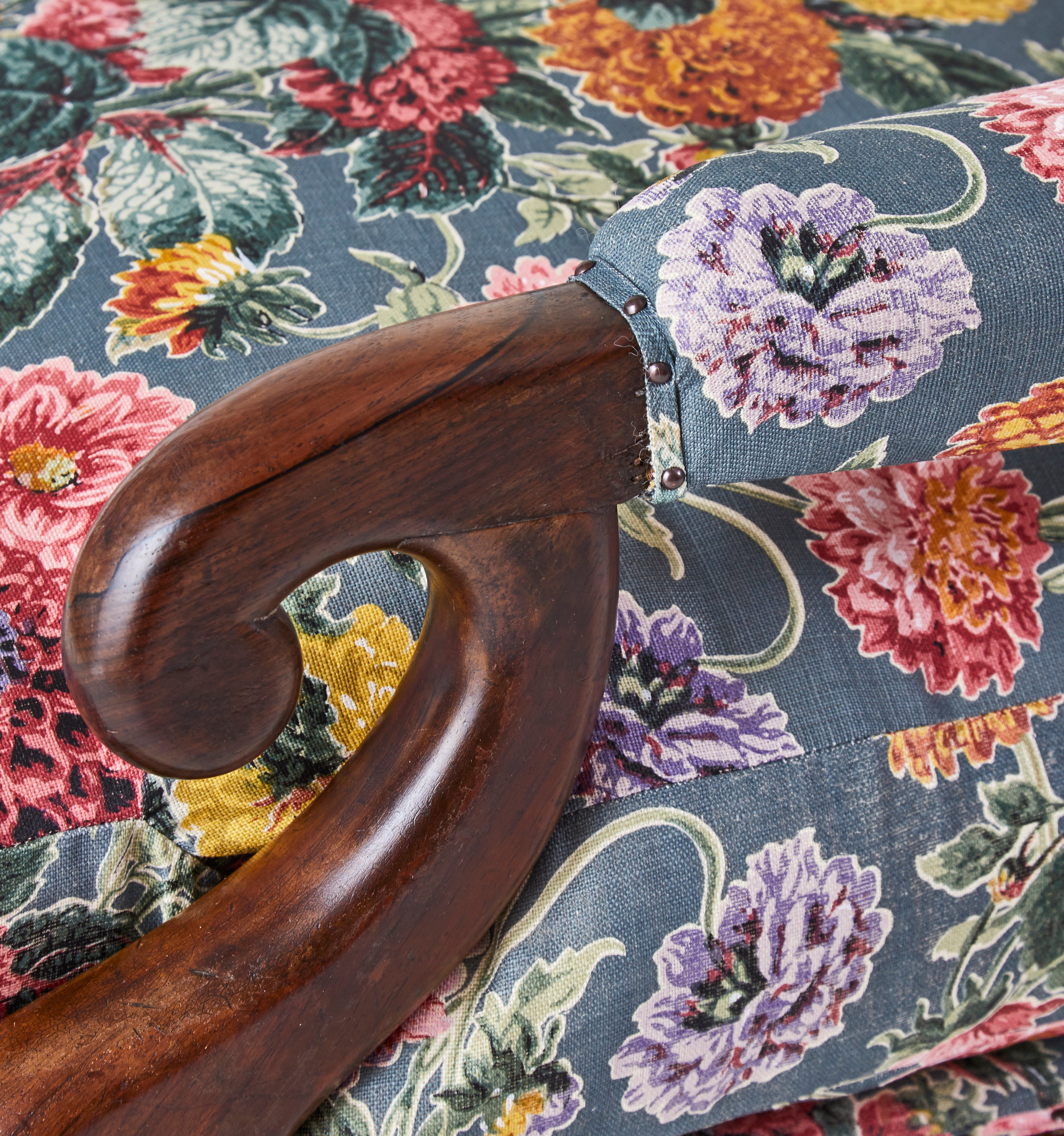 A 19th Century Round backed scroll armed chair upholstered in Flora Soames Dahlias