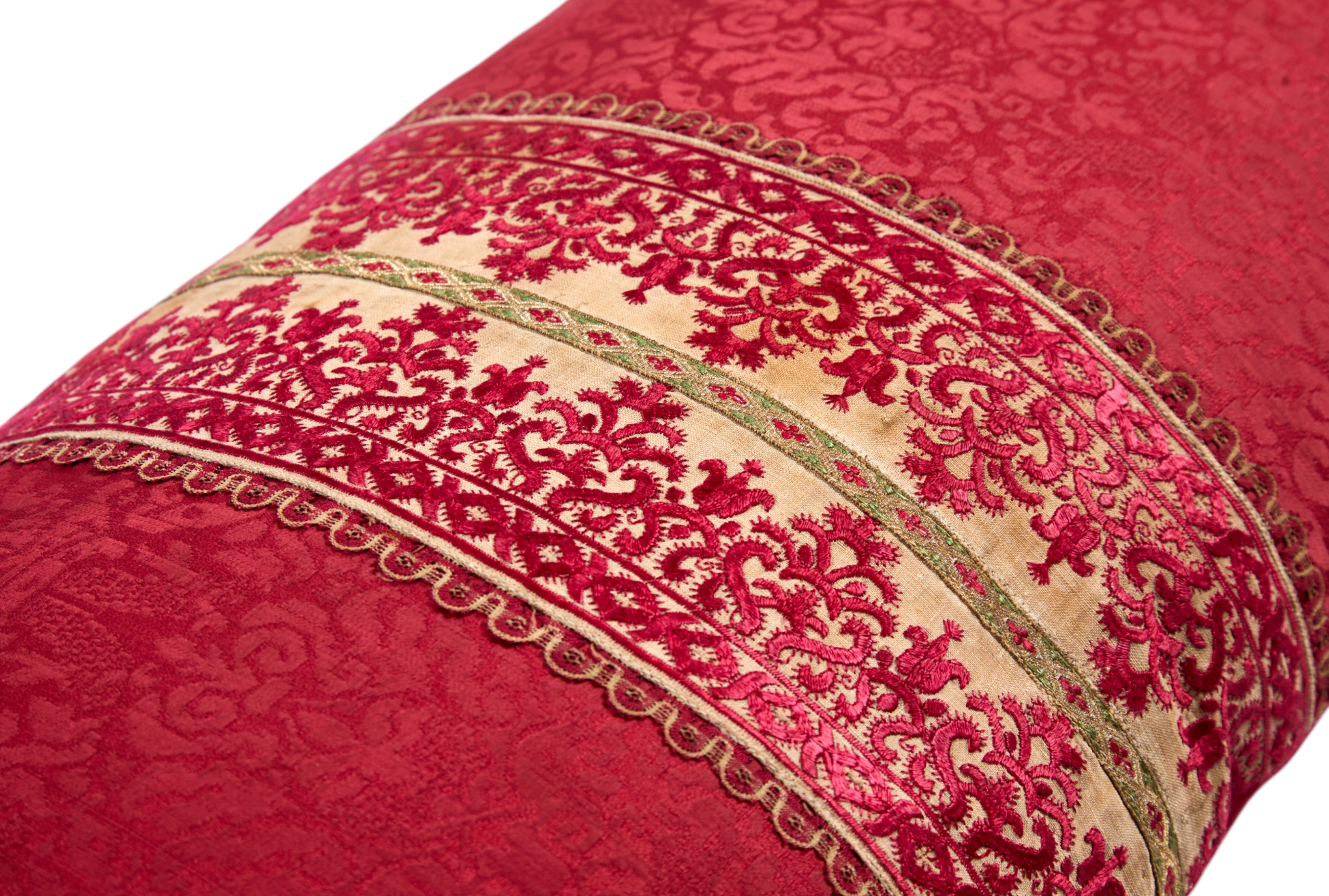 A long oblong cushion in a scarlet silk damask with 18th Century Greek Embroidered silk panel and Italian silk tassles