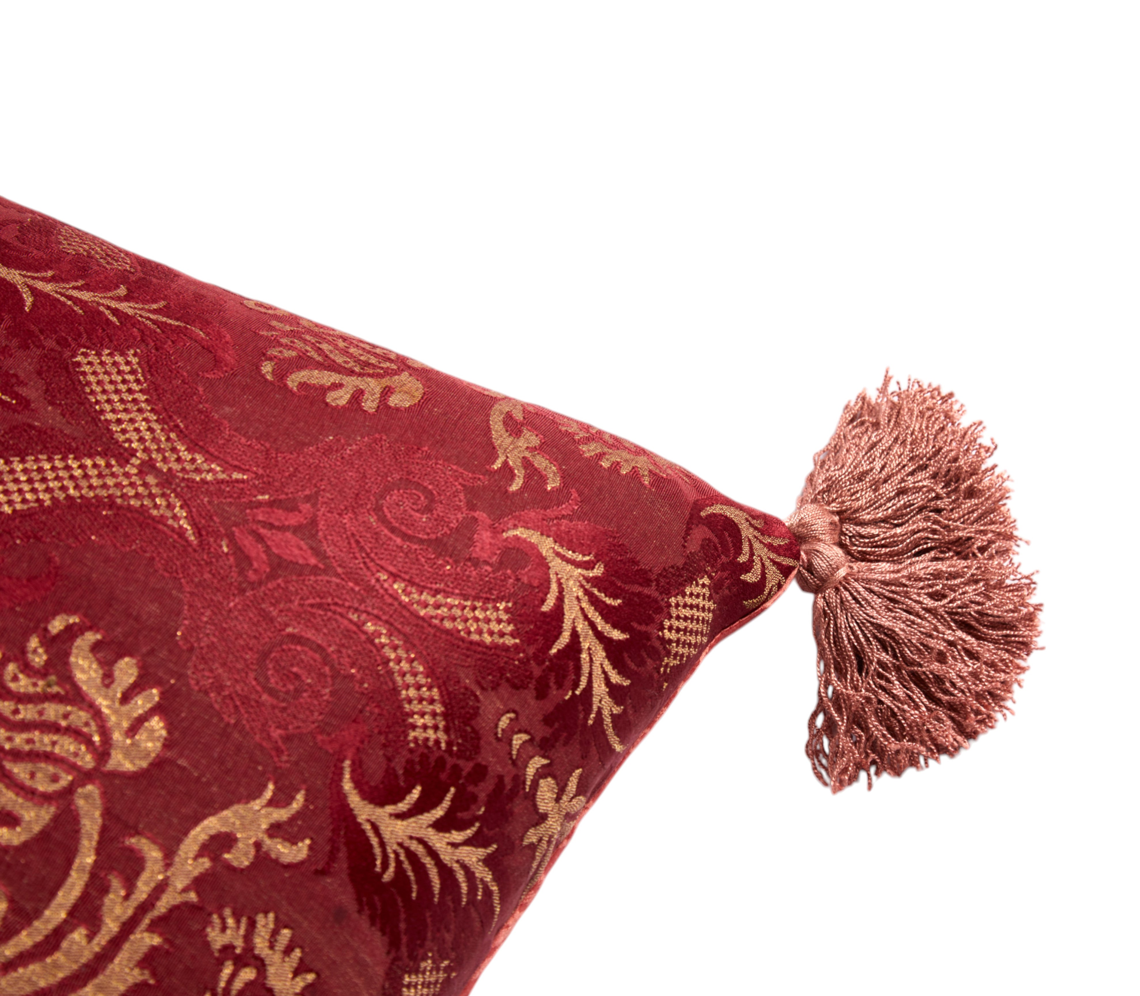A Claret Bolster Cushion made from antique woven damask with an 18th Century trim
