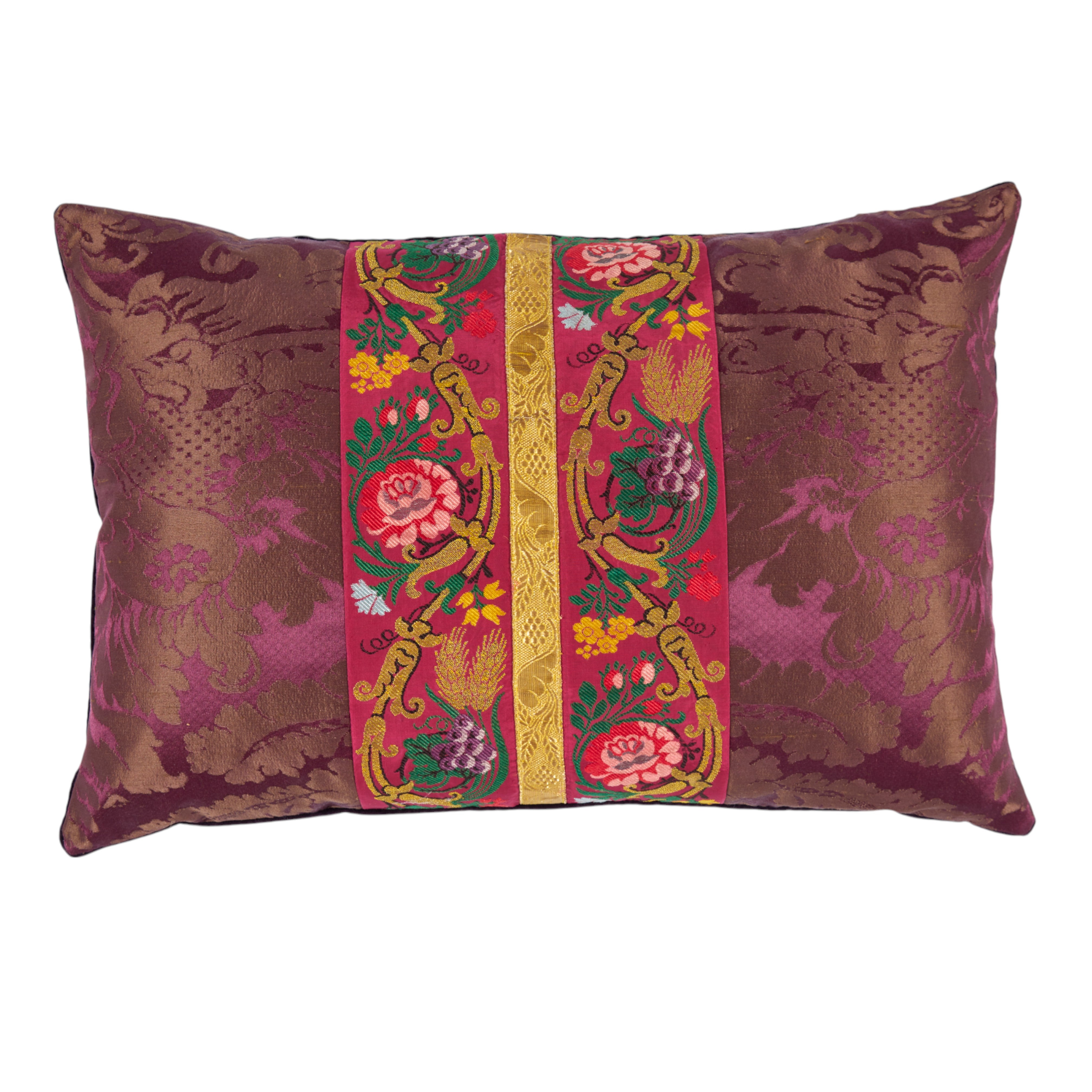 A pair of aubergine silk damask cushions with a central 19th Century embroidered trim