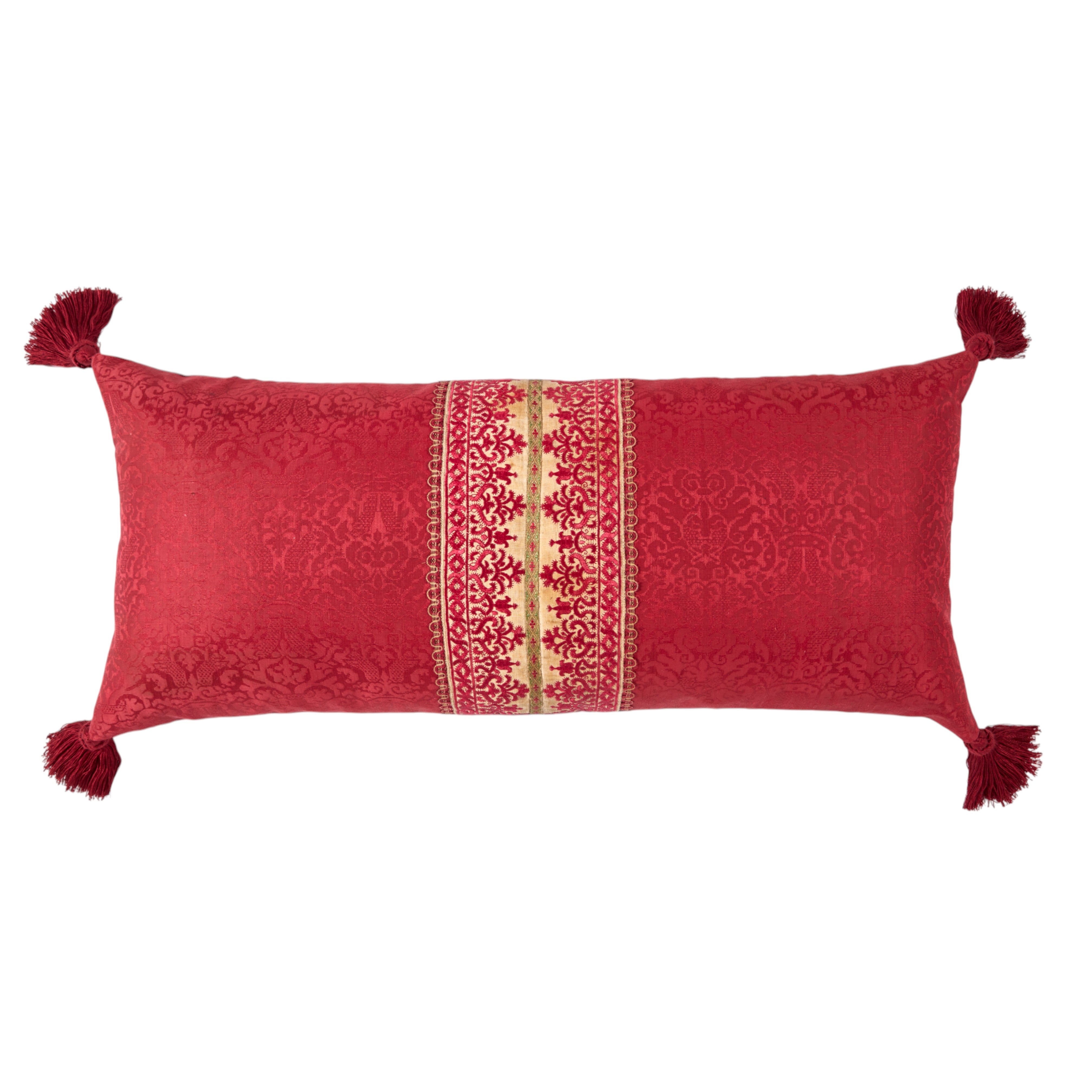 A long oblong cushion in a scarlet silk damask with 18th Century Greek Embroidered silk panel and Italian silk tassles