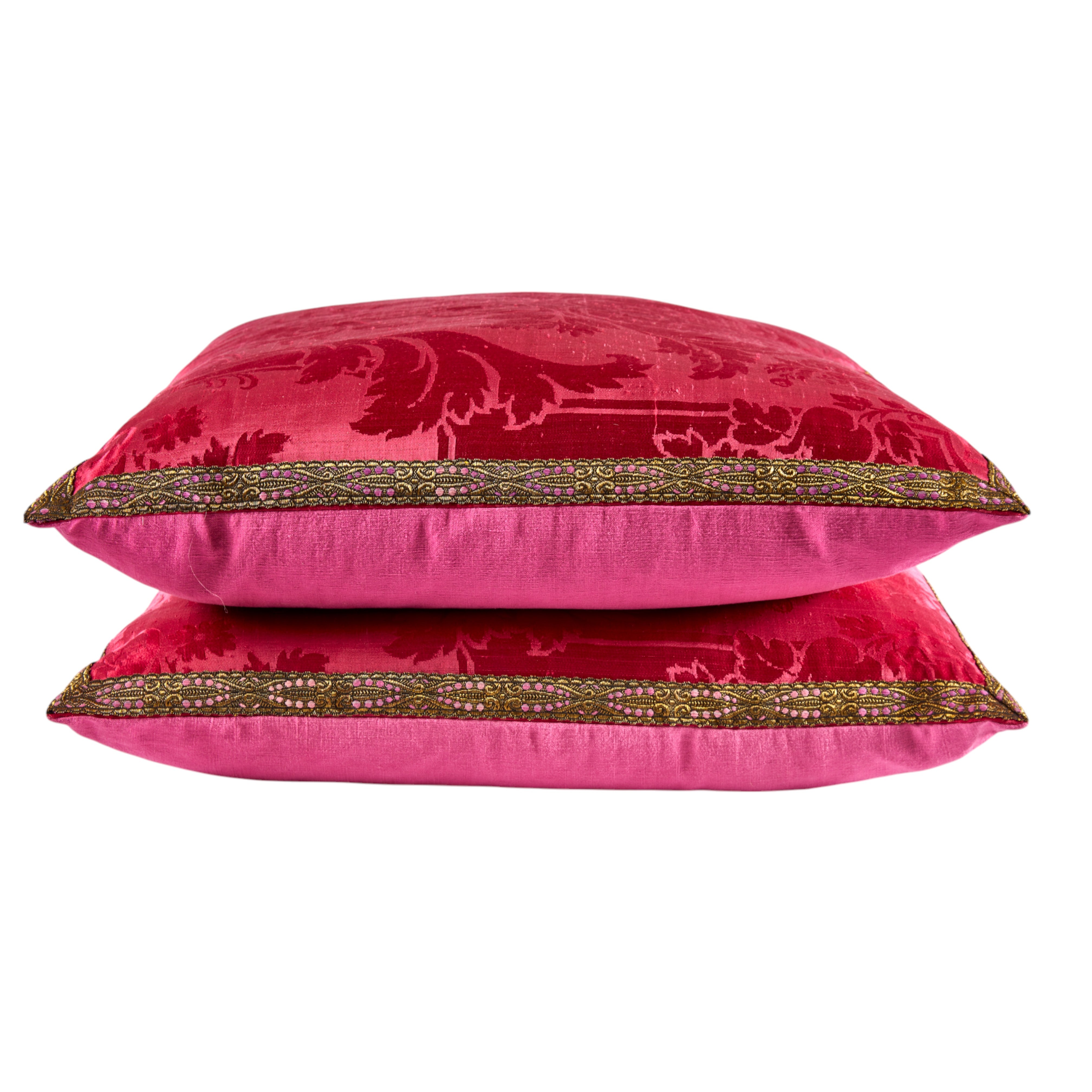 A large Pair of opulent Cranberry Silk 19th Century Damask Cushions with old gold flat braid decoration